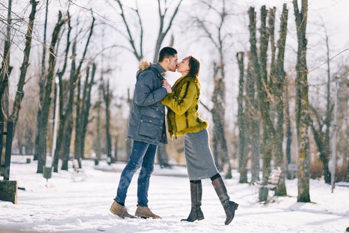 Preview: happy couple walking through the park on a sunny winter day