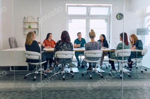 Preview: Diverse Business Team Discussing Projects in a Modern Glass Office.