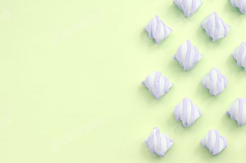 Preview: Colorful marshmallow laid out on lime paper background. pastel creative textures