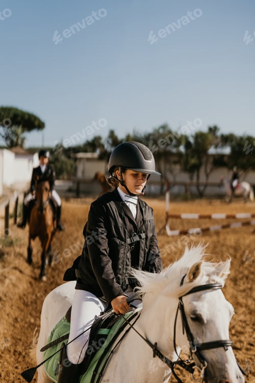 Preview: 12-year-old girl jogging white pony at riding school