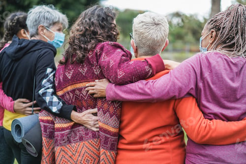 Preview: Multi generational women having fun before yoga class wearing safety masks
