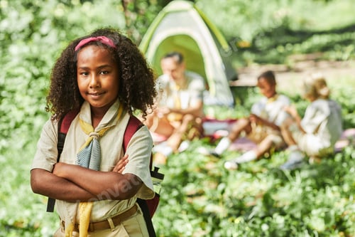 Preview: Girl scout looking at camera while camping