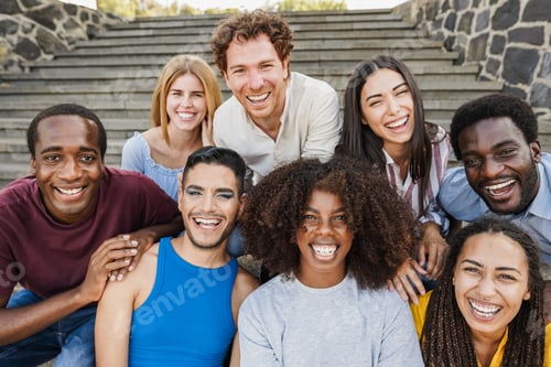 Preview: Young diverse people having fun outdoor laughing together - Focus on center african girl face