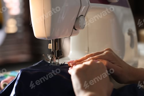 Preview: Woman working with sewing machine in workshop, closeup