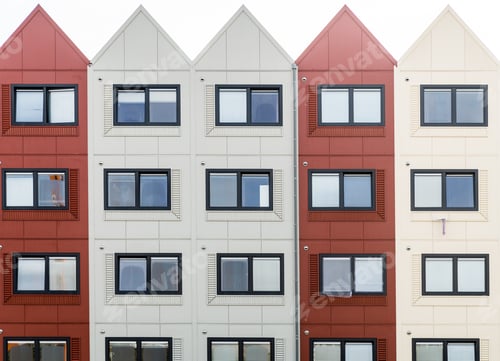 Preview: Closeup shot of a building with red and white sections and triangular roofs