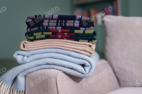 Preview: Stack of woolen checked blankets