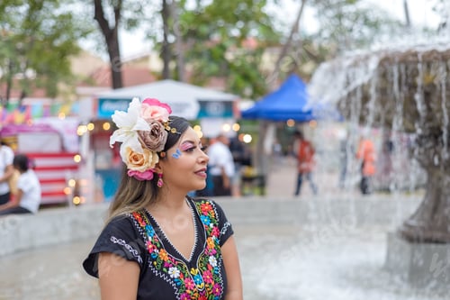 Preview: Mexican woman wearing traditional dress with multicolored embroidery celebrating independence day.