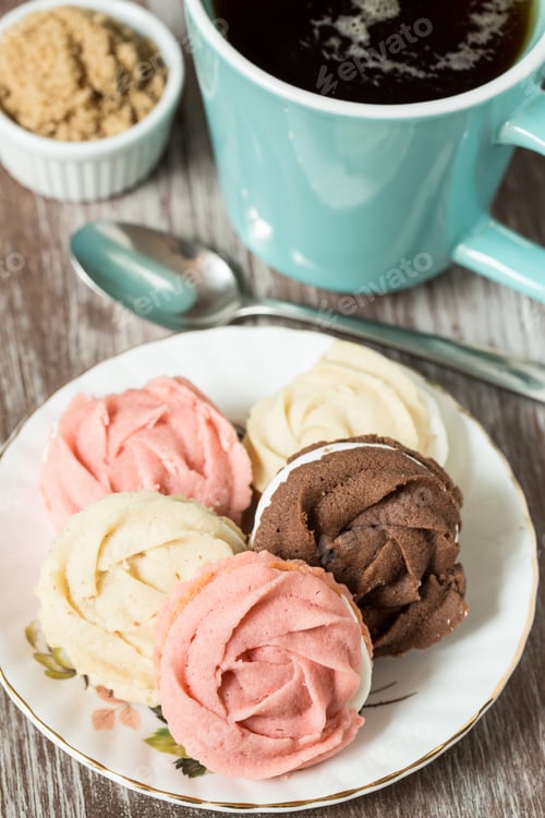 Preview: Plate Of Chocolate Vanilla And Strawberry Cookies With Cup Of Tea And Brown Sugar And Spoon