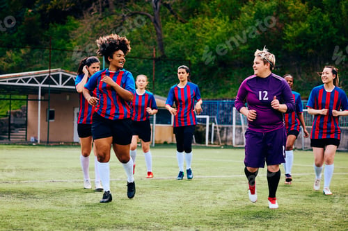 Preview: Women's soccer team warming up during sports training on playing field.