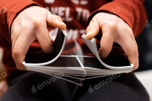 Preview: Closeup of person's hands shuffling the card deck on the table