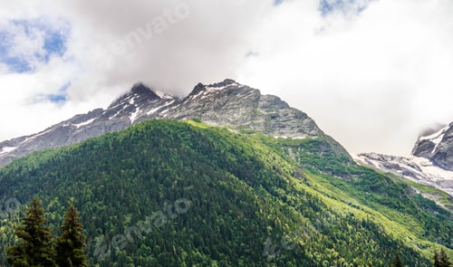 Preview: Snow-capped mountain peaks in summer