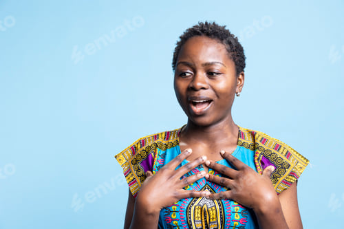 Preview: African american girl acting surprised after seeing something in studio