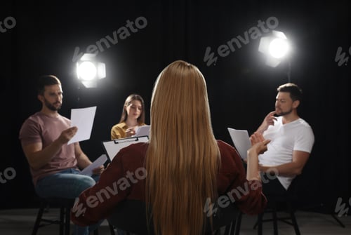 Preview: Professional actors reading their scripts during rehearsal in theatre