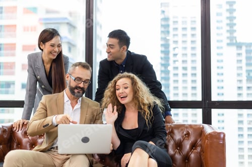 Enthusiastic Colleagues Videoconferencing in Modern Workplace