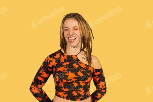 Preview: Young woman with dreadlocks winking, sticking out tongue