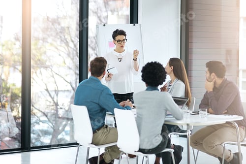 Preview: Cropped shot of a businesswoman giving a presentation to her colleagues in a modern office