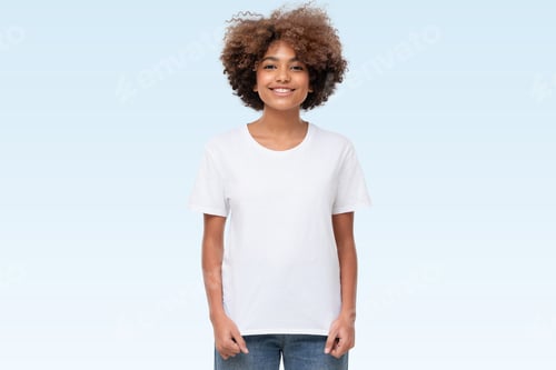 Preview: Front view of african american girl standing, wearing blank t-shirt with copy space