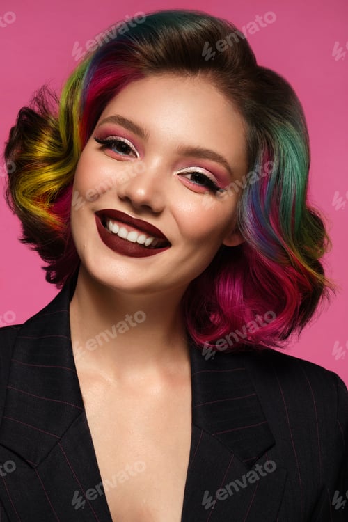 Preview: Beautiful woman with multi-colored hair and bright make up and hairstyle.