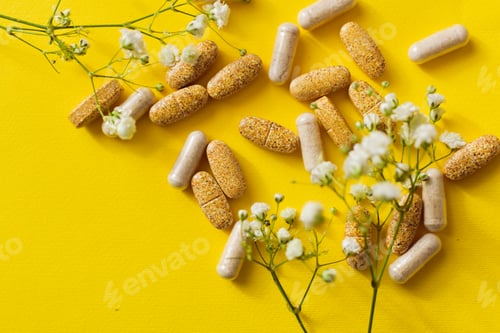 Preview: Pills and vitamins on yellow background