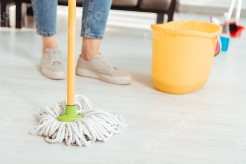 Preview: Cropped view of woman cleaning floor with mop