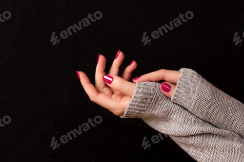 Preview: Hands with Painted Nails Wearing Sweater Sleeves