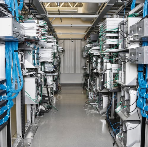 Preview: Server room aisle showing computer servers and CAT 5 cables.