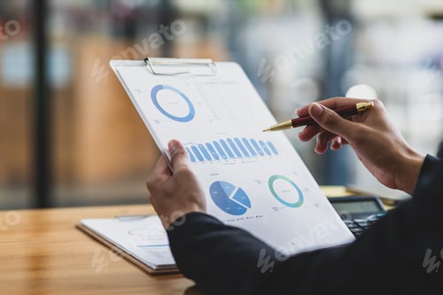 Preview: Businessman working on paperwork is analyzing business financial statistics.