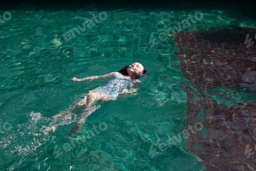 Preview: Girl floating in pool