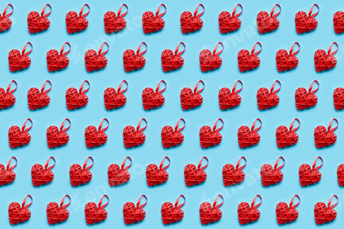 Preview: Red wicker heart on blue background. Seamless pattern. Valentines day concept, top view