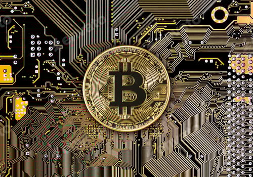 Preview: Bitcoin coins on black circuit board