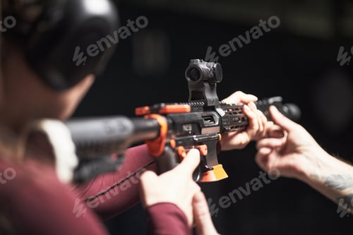 Preview: Anonymous Female Customer Practicing Aiming Rifle during Shooting Club Training