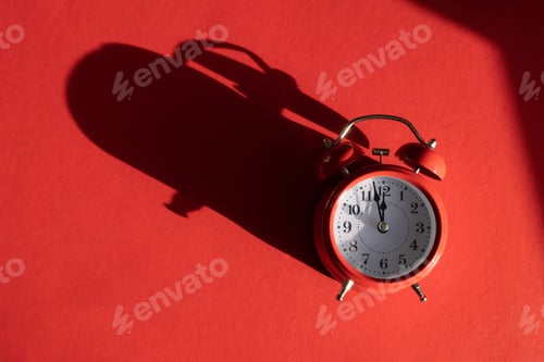 Preview: Red alarm clock with overlay shadow isolated on red background. Christmas and New Year greeting card