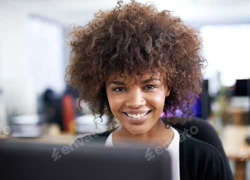 Preview: Cropped shot of an attractive young working at a desk with her colleagues in the background