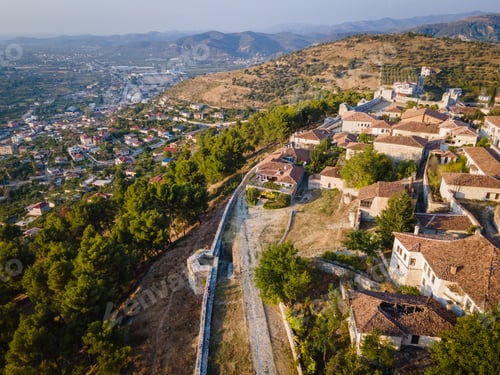 Preview: Aerial view of the old Castle in Berat and its ancient neighborhoods in sunset light