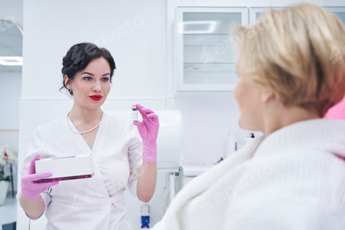 Preview: Woman Medical Professional Holding Vial in Clinical Setting