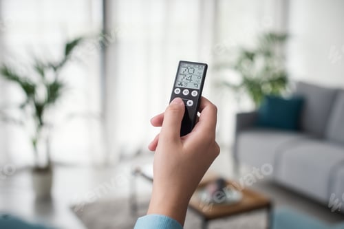 Preview: Woman controlling the room temperature remotely