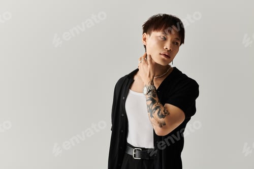 Preview: Stylish Asian man showcasing modern fashion and unique tattoos in a minimalist setting