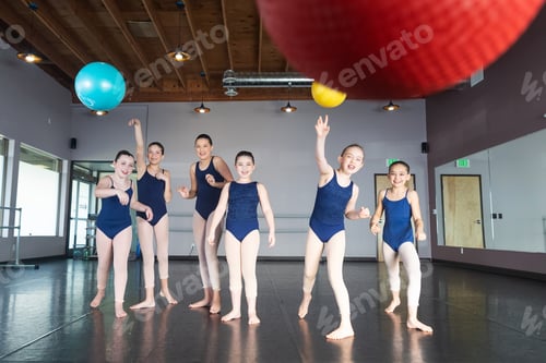 Preview: Group of young girls in dance class studio throwing balls in game of dodge ball