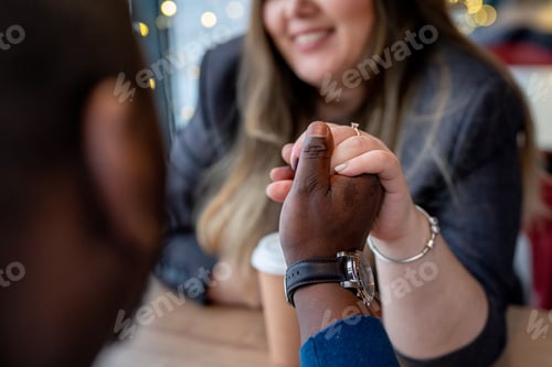 Preview: Happy diverse couple. Beautiful smiling woman with a man drinking coffee in a cafe.