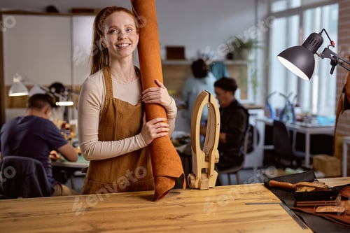 Preview: beautiful female tailor with fabric rolls.