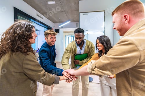 Preview: Startup business team joining hands in modern office, celebrating success and teamwork