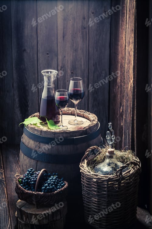 Preview: Fresh homemade wine in glass with grapes and demijohn