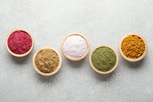 Preview: Different superfood powders on light grey table, flat lay