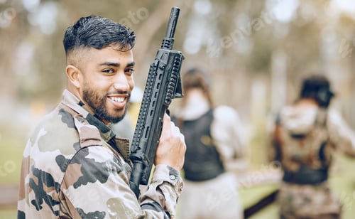 Preview: Paintball gun, man and portrait with smile, camouflage clothes and excited to start military combat