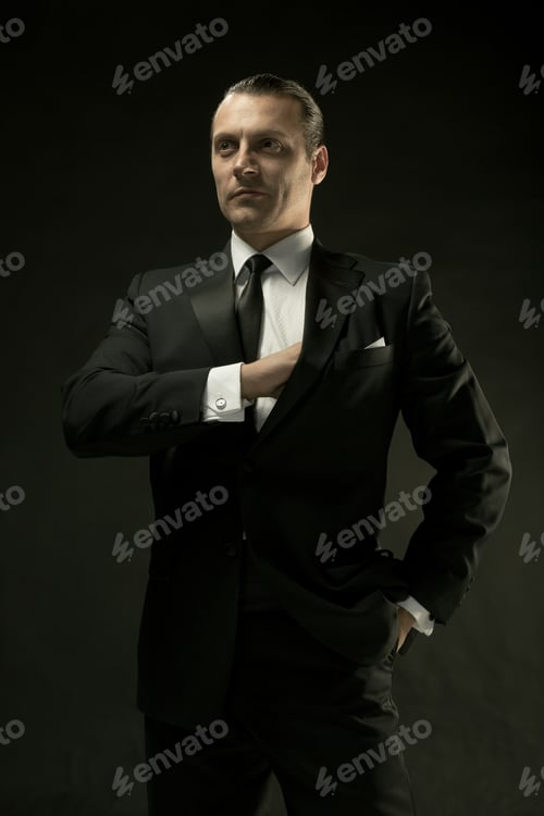 Preview: The Attractive Man In Black Suit On Dark Background