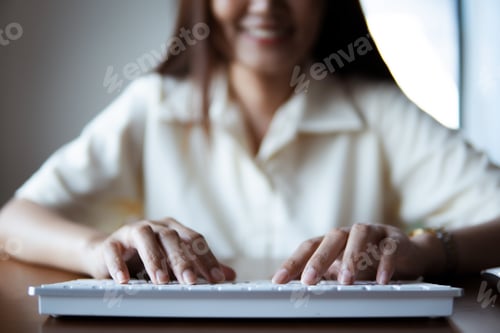 Preview: Close up of business people using computer laptop on wooden table.