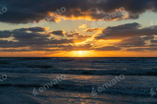 Preview: Ocean sunset landscape with soft evening sea water waves crushing on sandy beach