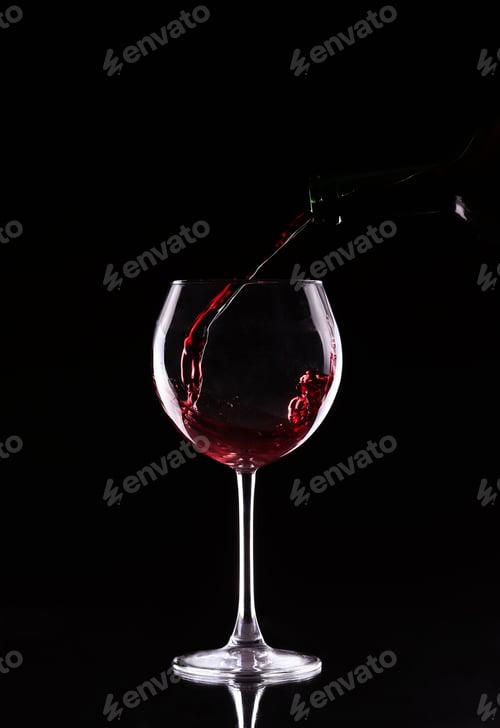 Preview: bottle and glass with red wine on a black background