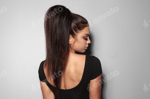 Preview: Young Woman with Stylish Ponytail Poses Elegantly