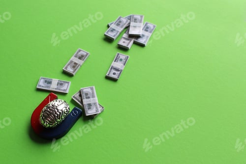Preview: Brain and magnet attract money on green background
